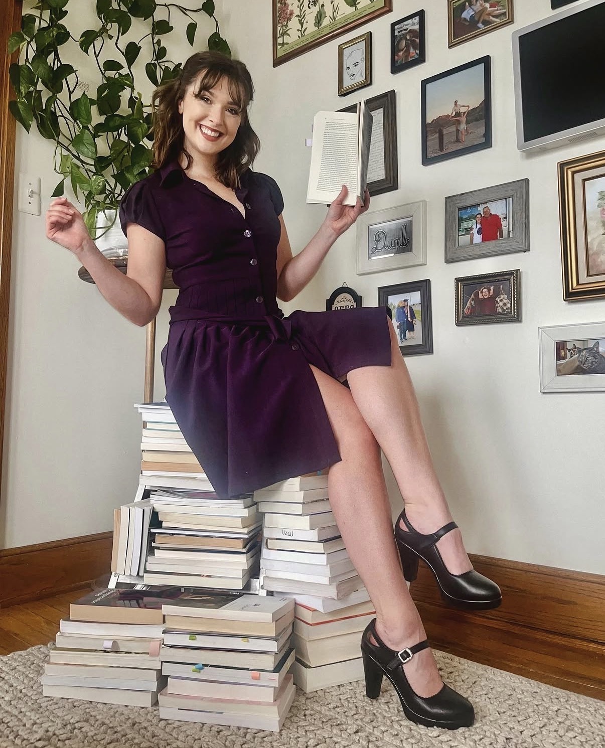 Me sitting on all of the (print) books I read during my PhD coursework!